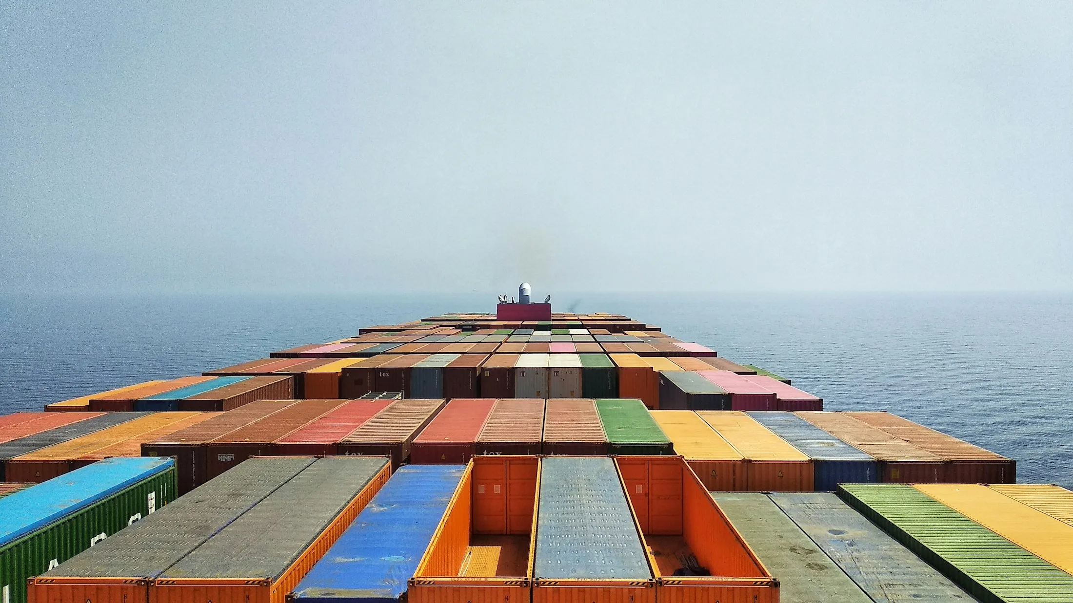 Looking forward over a loaded container deck to the open horizon.